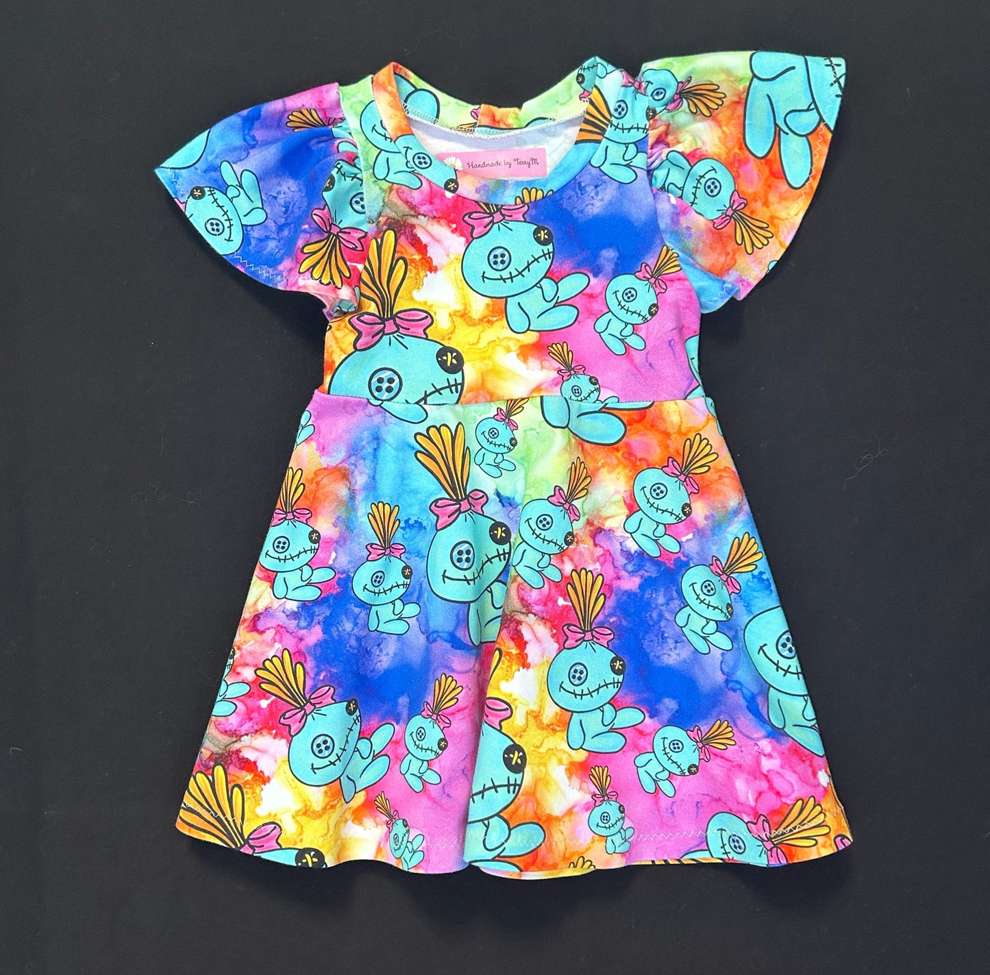 “Colourful alien doll baby dress – size 1”
“Handmade toddler skater dress multicolour”