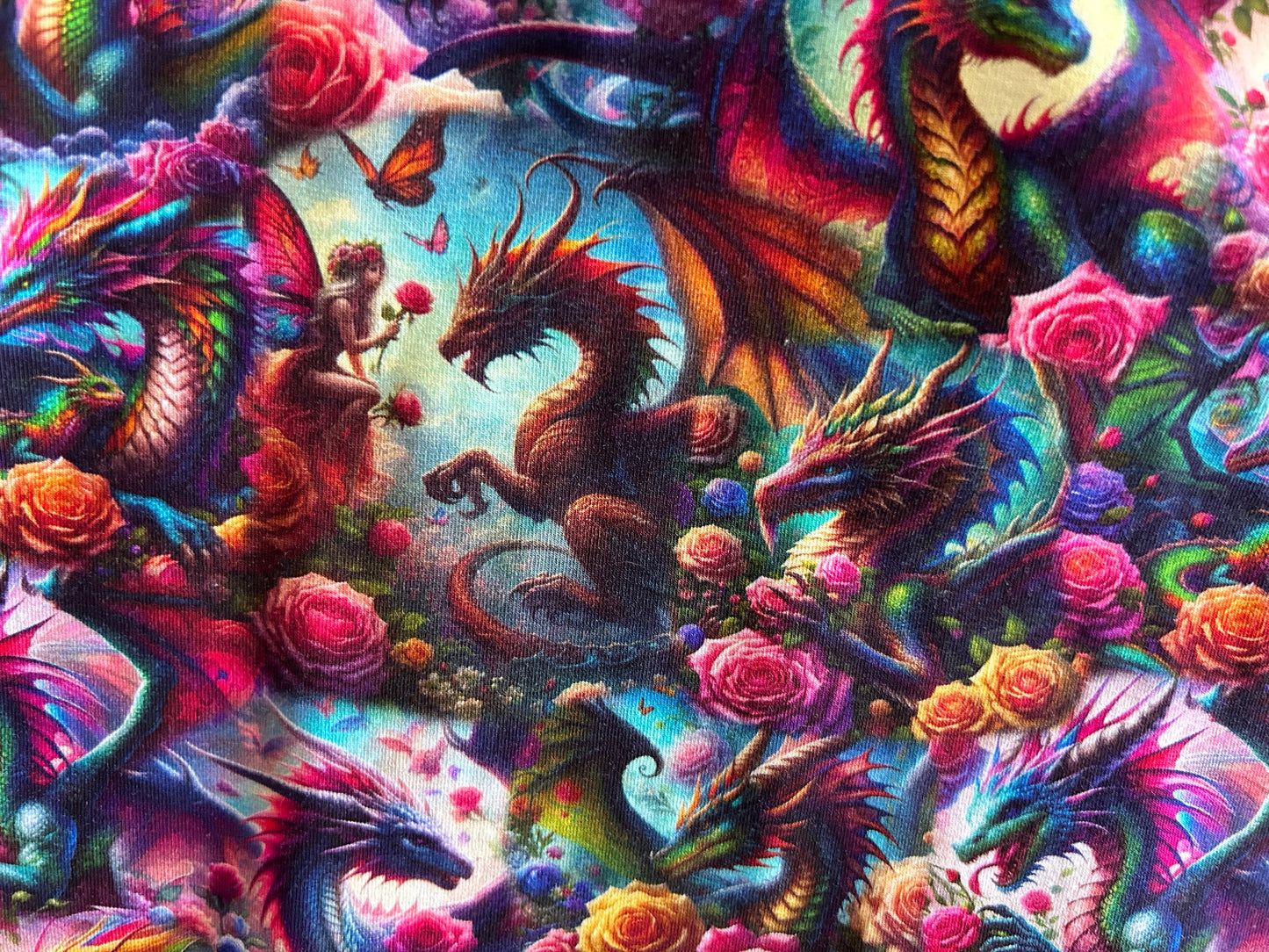 Colorful artwork of dragons and fairies intertwined with flowers