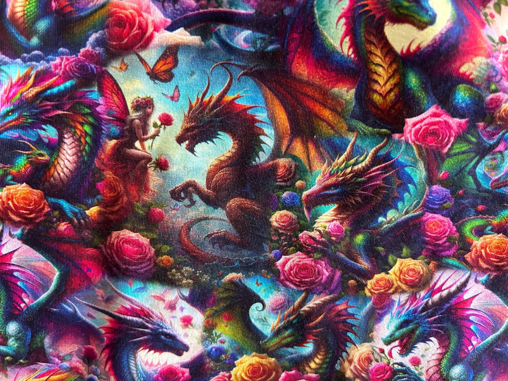 Colorful artwork of dragons and fairies intertwined with flowers